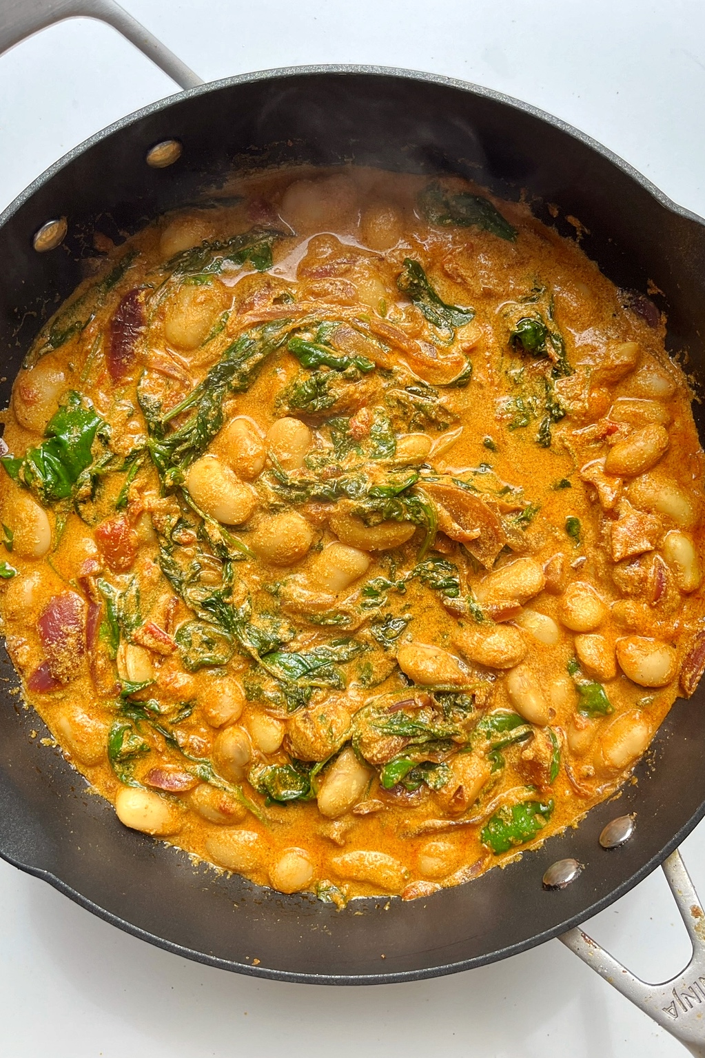 butterbean curry in a non-stick frying pan.
