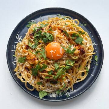 Tahini Chilli Oil Spaghetti with egg yolk on black plate