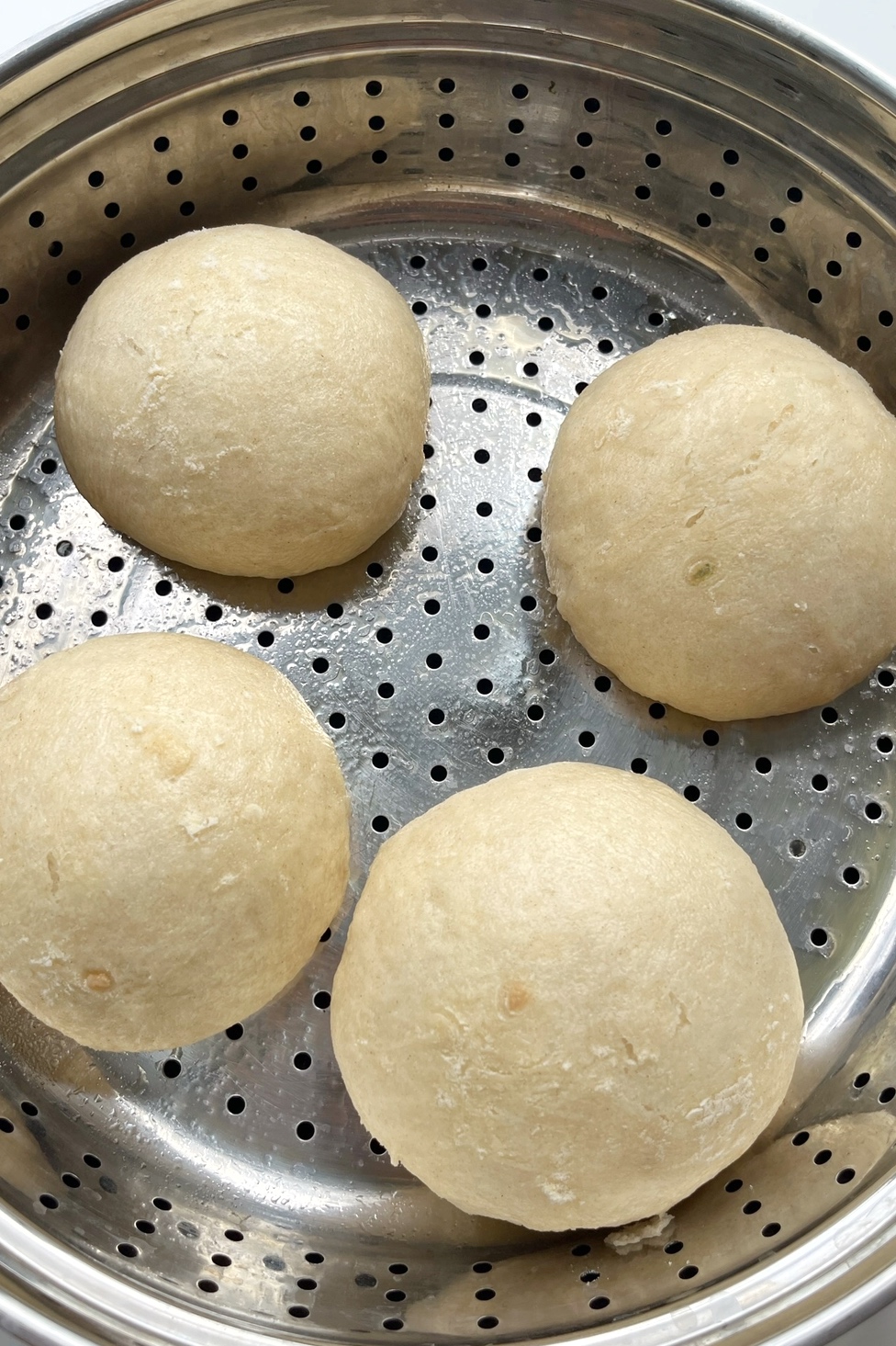 Steaming bao buns in a steamer. 