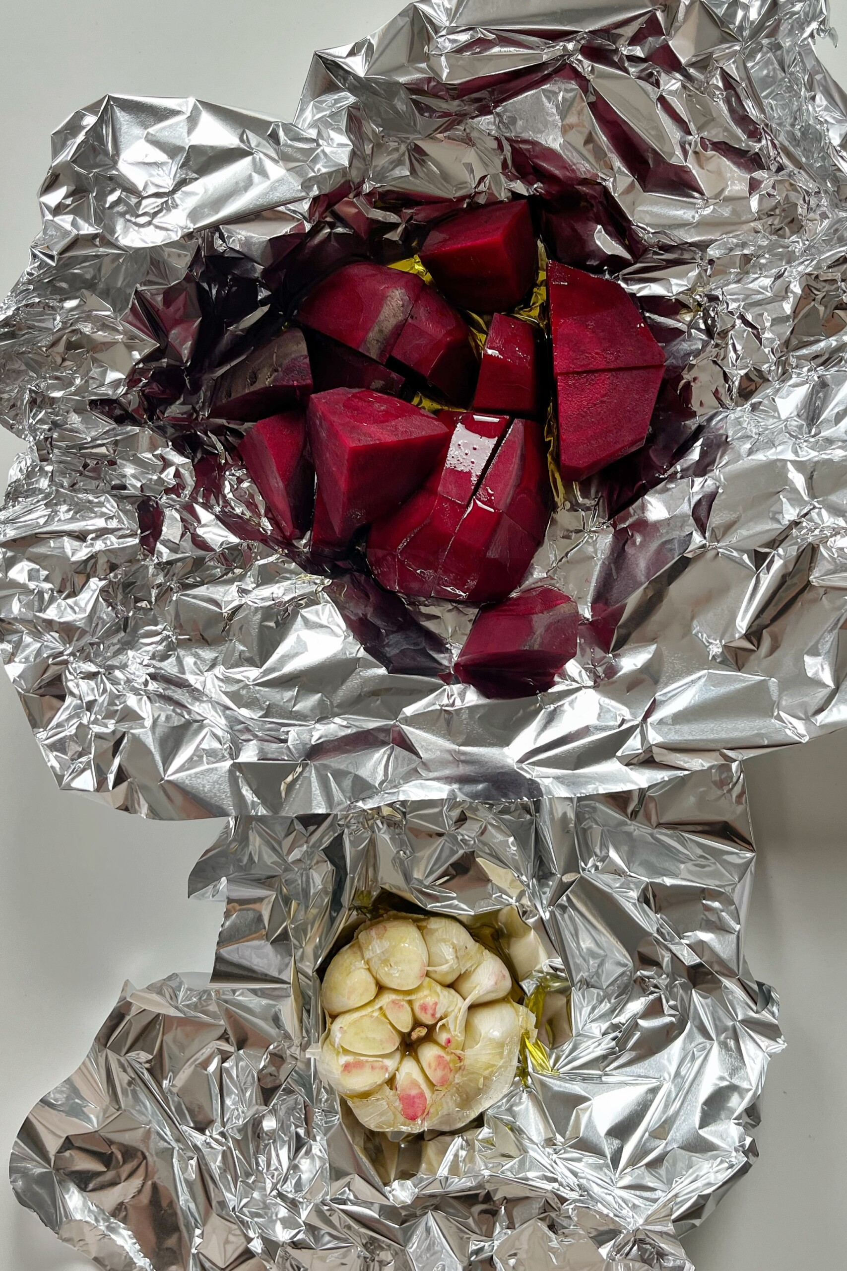 Roasting beetroot and garlic in tin foil.