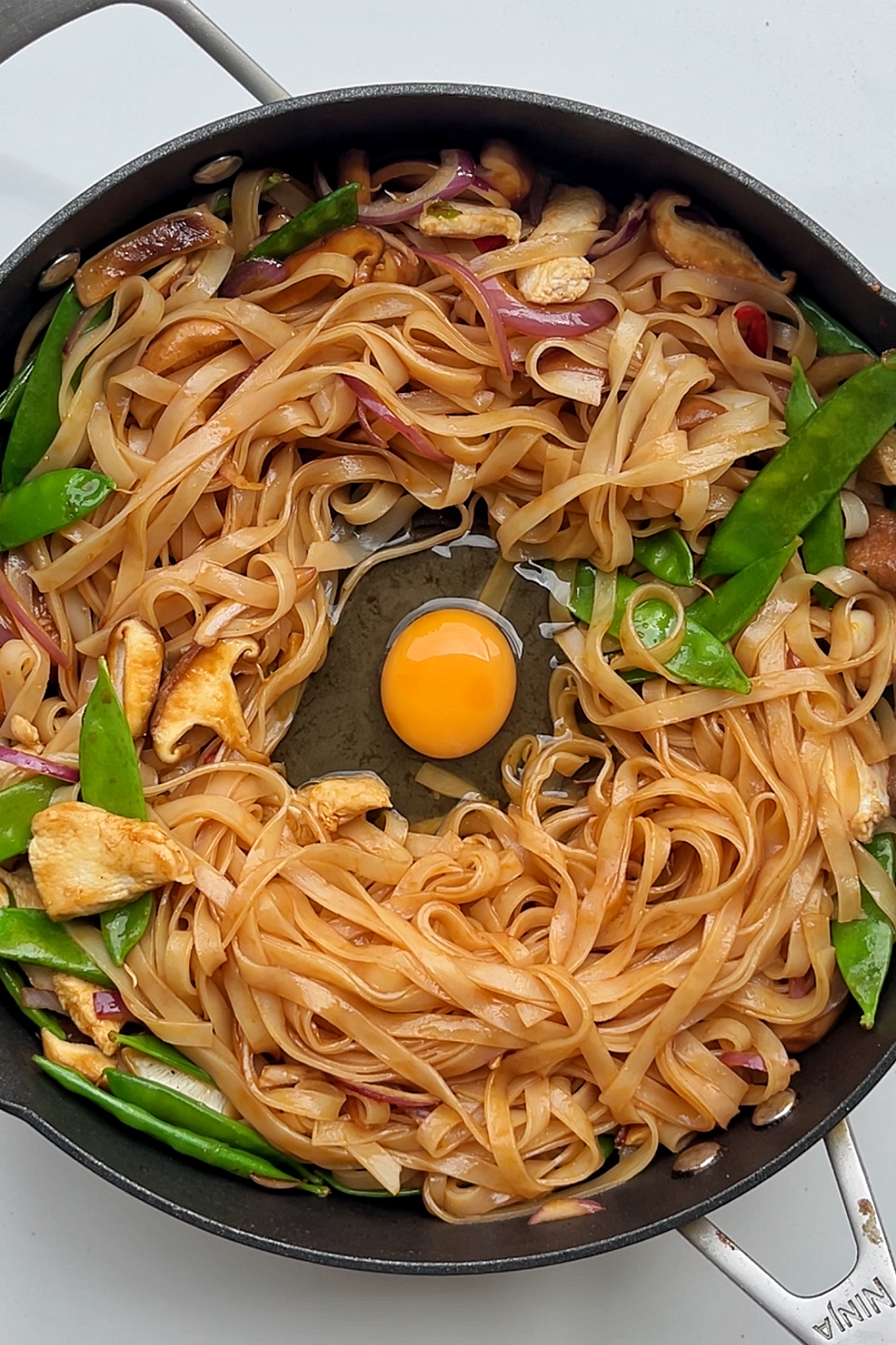 Stir fried noodles with egg in the centre.