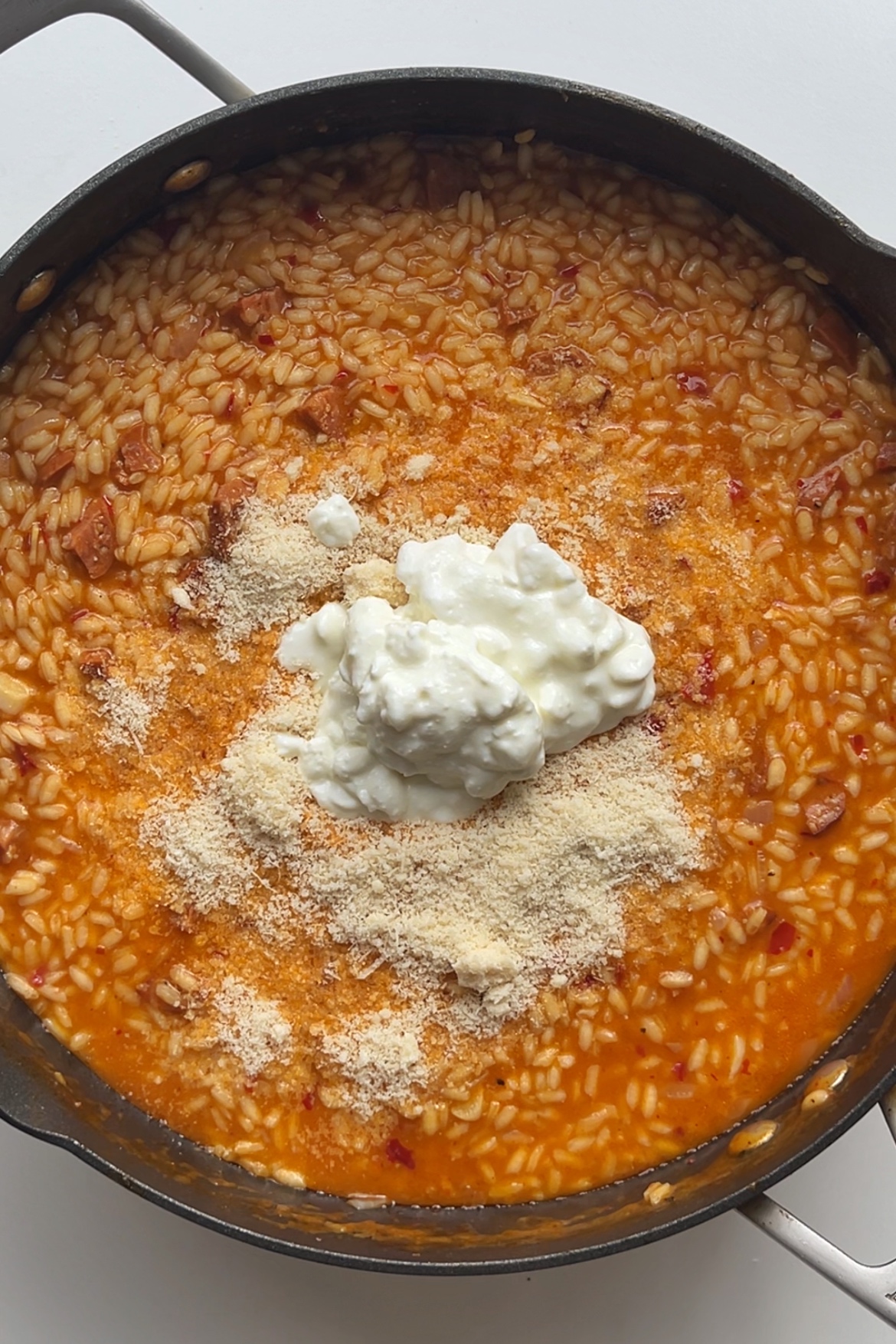 'Nduja risotto topped with cottage cheese and parmesan.