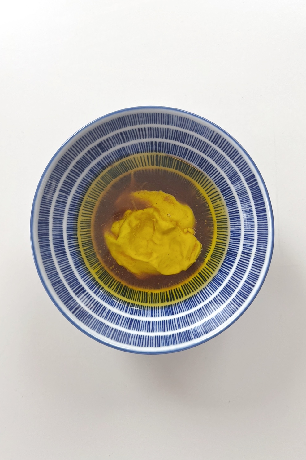 Dijon mustard, red wine vinegar, and olive oil in a bowl. 