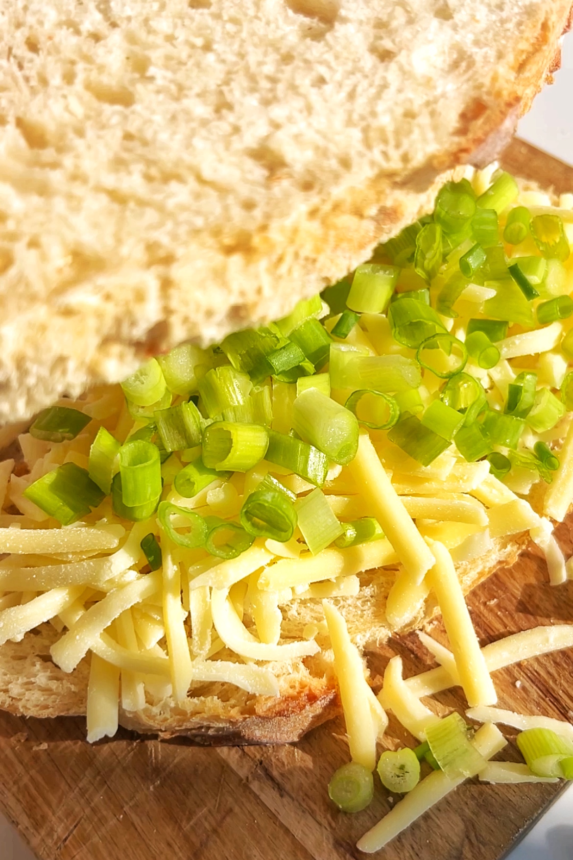 Close up of a cheese toastie with spring onions.