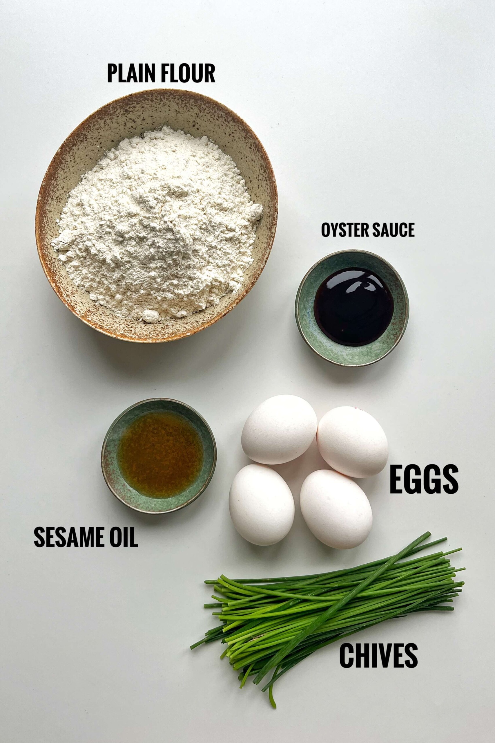 List of ingredients for chive pockets including plain flour, oyster sauce, sesame oil, eggs, and chives. 