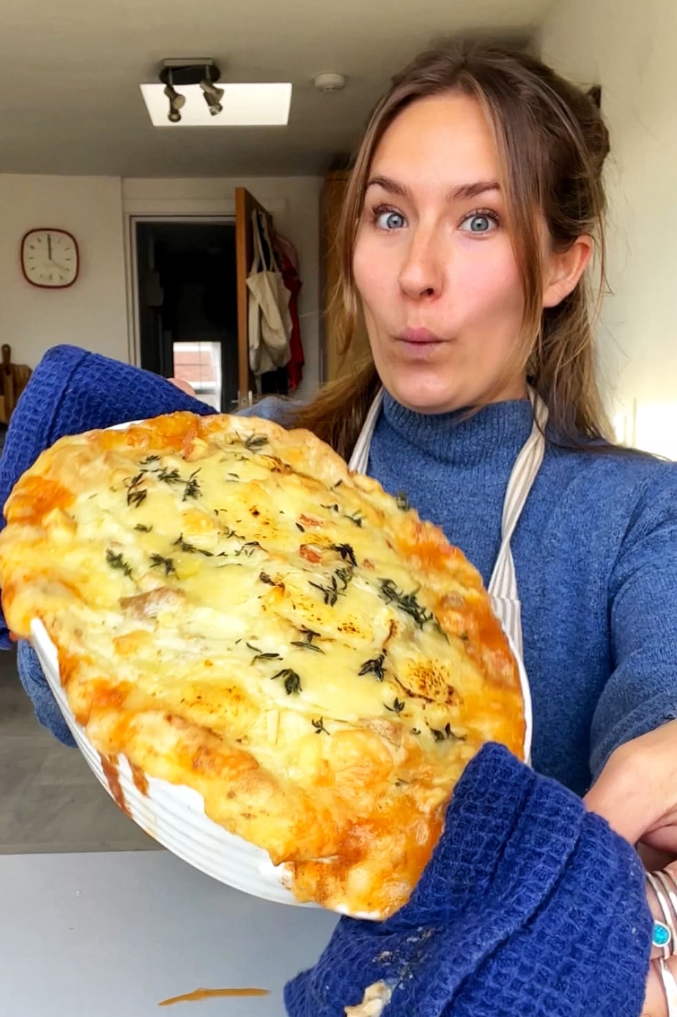 Emily Roz holding up picture of French onion cottage pie. 
