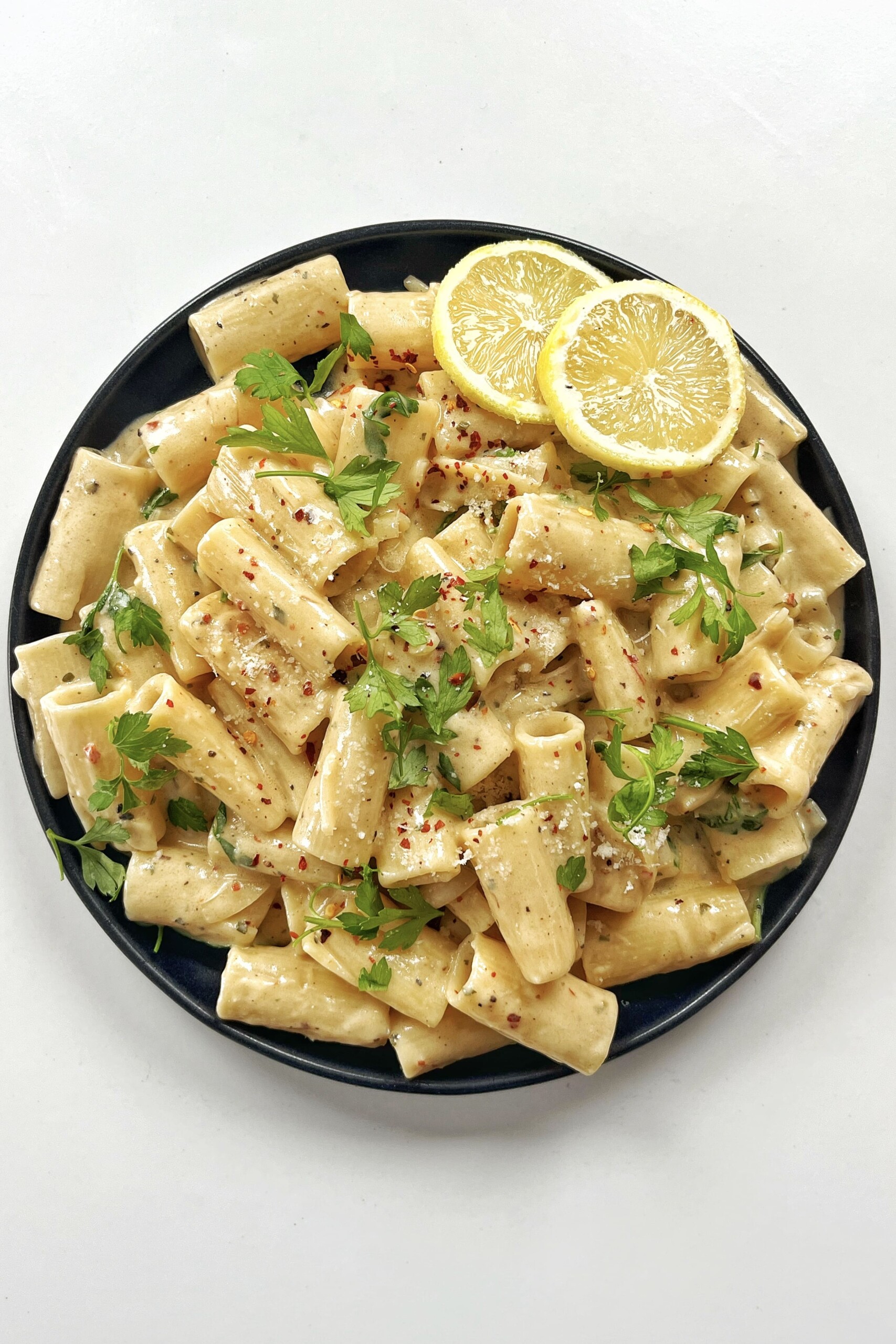 Lemon Boursin Pasta on black plate.