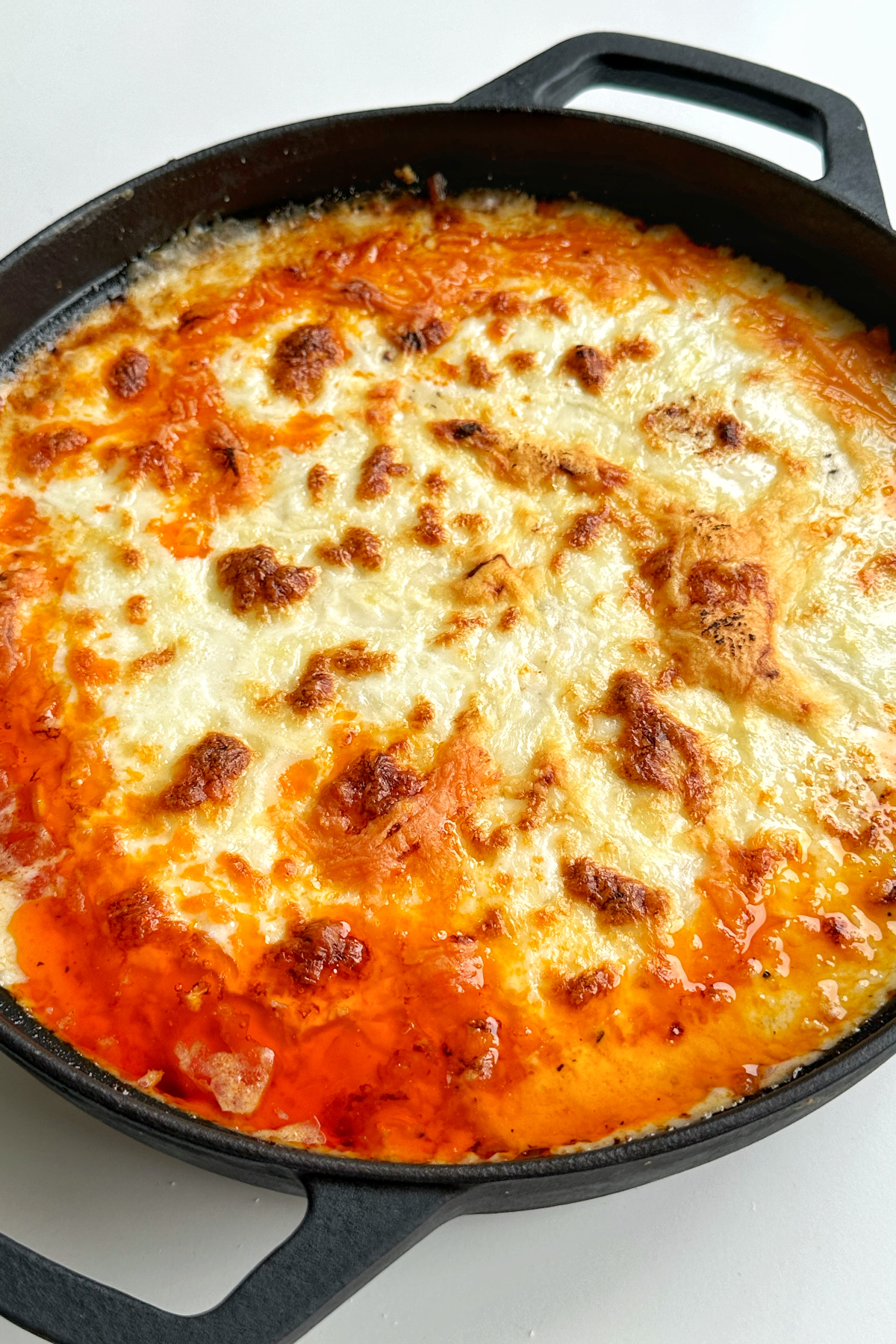 Black casserole dish filled with gnocchi gochujang lasagne.