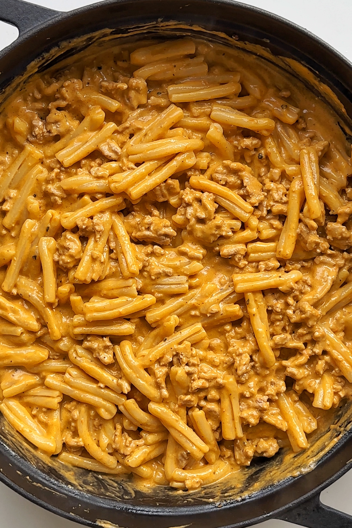 Pasta bake with turkey in a black pan.