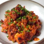 jacket potato topped with cheesy beans, fried chorizo and chives.