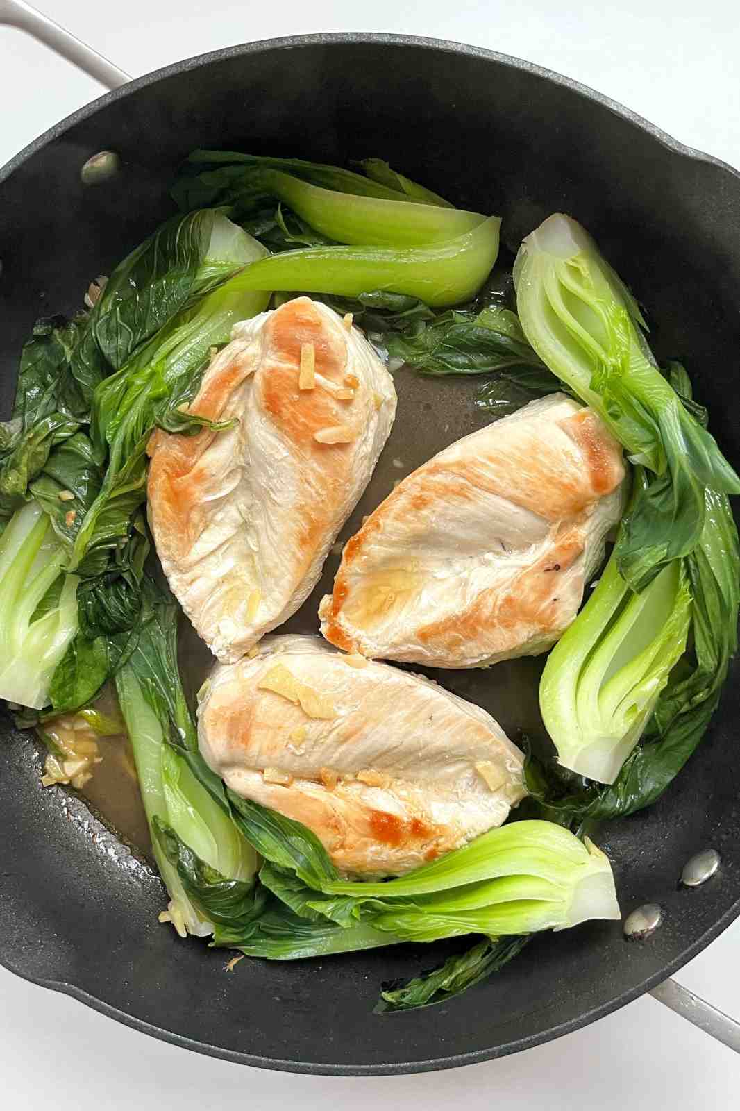 Frying pan with pak choi and chicken