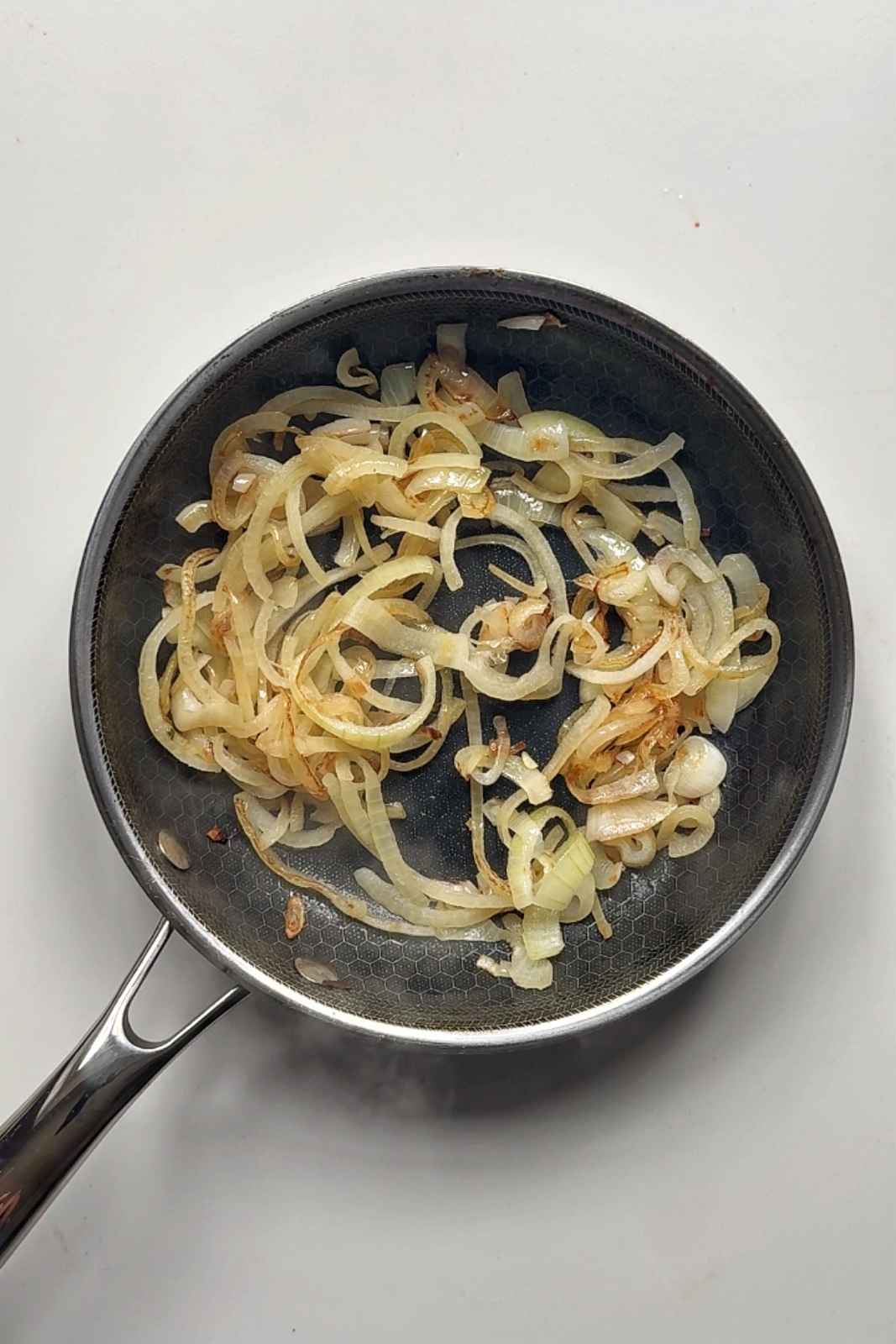 Frying onions in a pan.