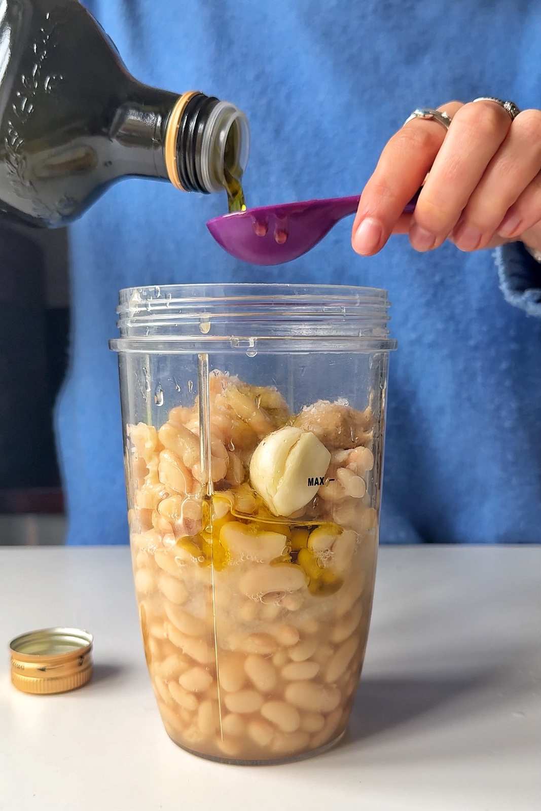 adding ingredients to a blender.