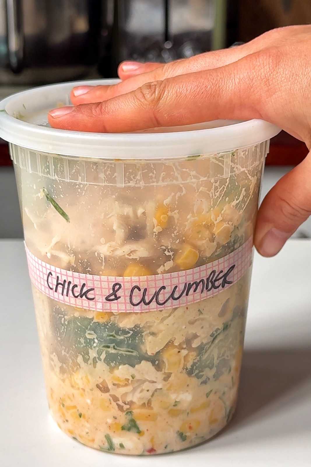 Chicken cucumber salad in tupperware.