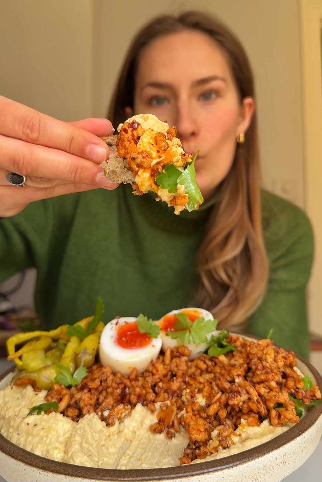 Emily eating chicken hummus bowl.