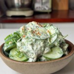 Cucumber dill salad in a brown bowl.
