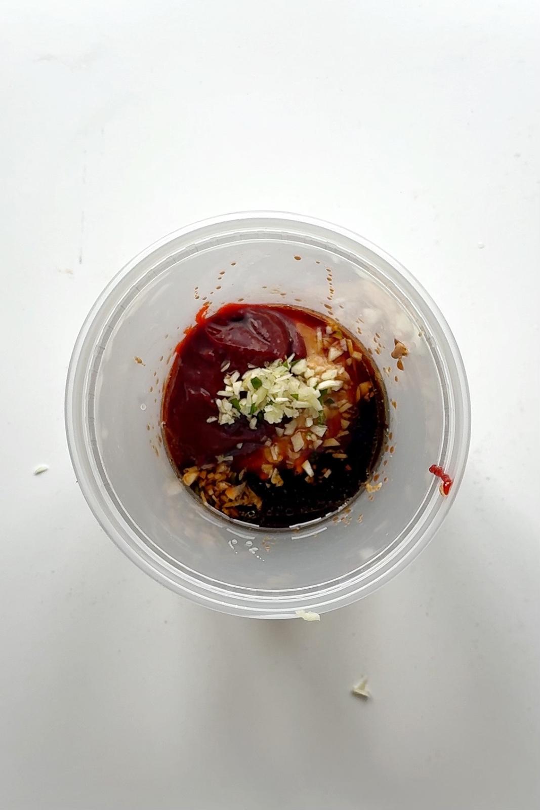 Plastic tupperware filled with spicy filling.