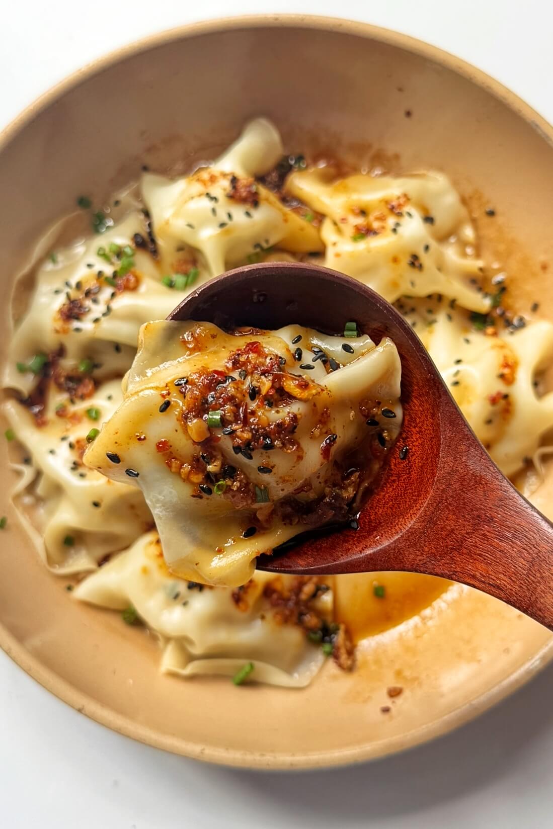 Viral blanket dumplings being held up by a spoon.