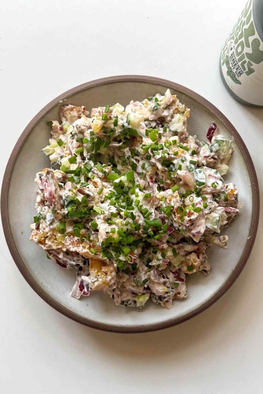 Serving up the crispy smashed potato salad in a bowl.