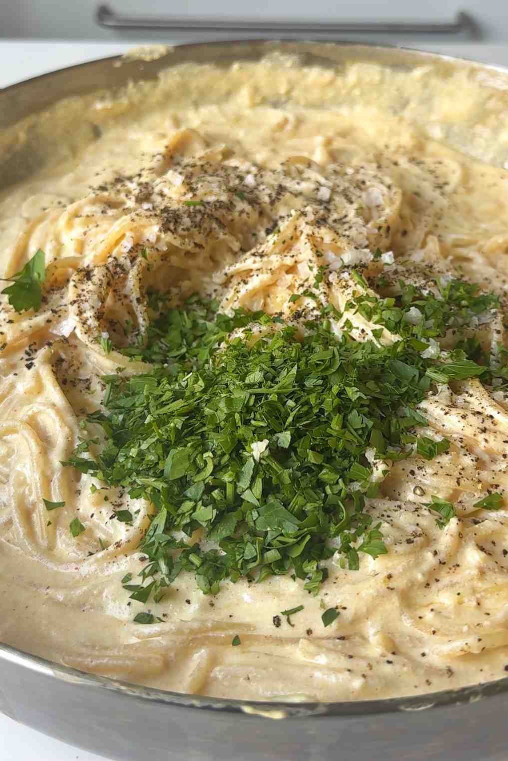 Adding finely chopped parsley to the silken tofu sauce.