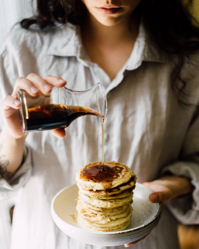 Sorghum syrup drizzled onto pancakes, a Southern alternative to maple syrup.