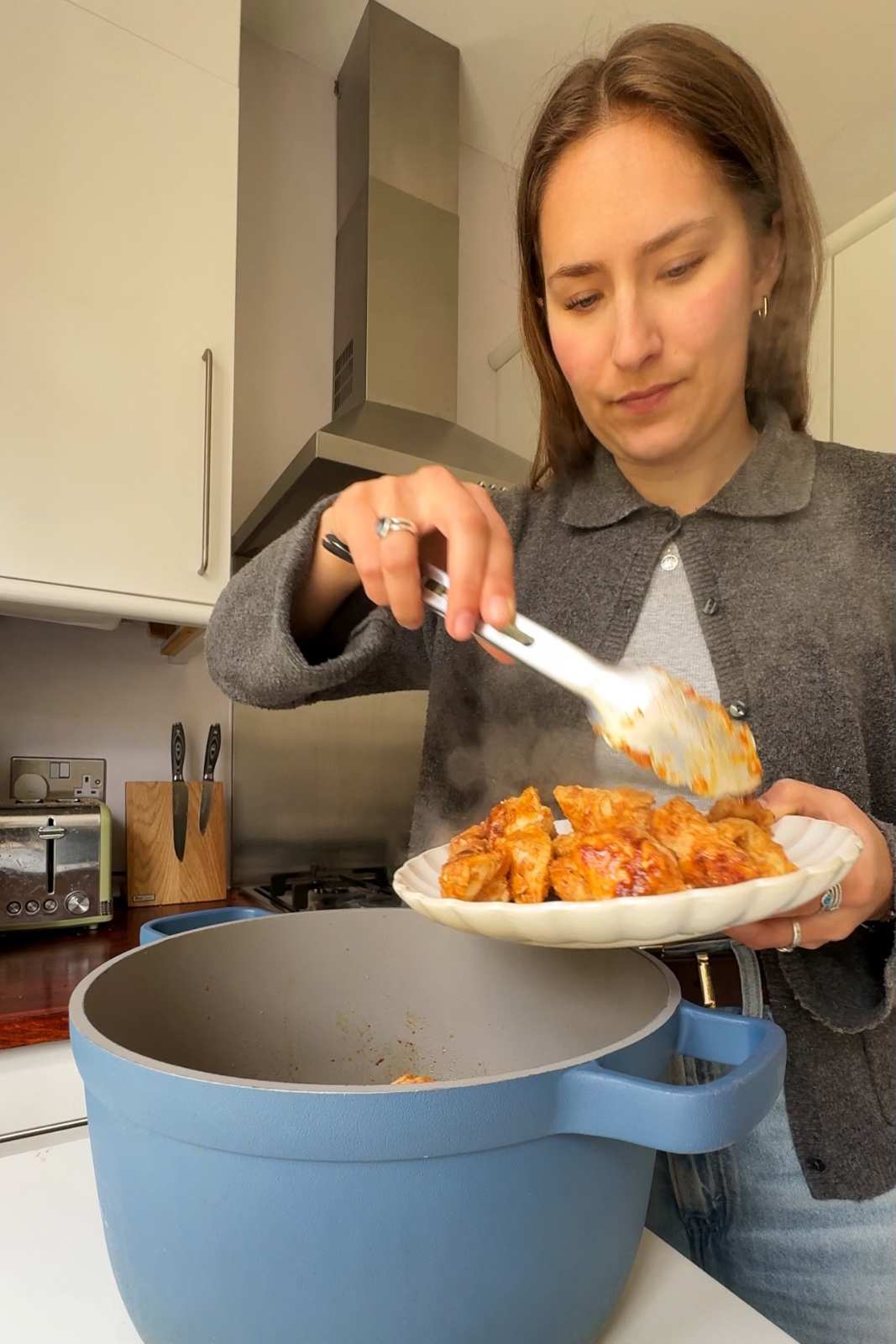 Removing chicken from a pot.