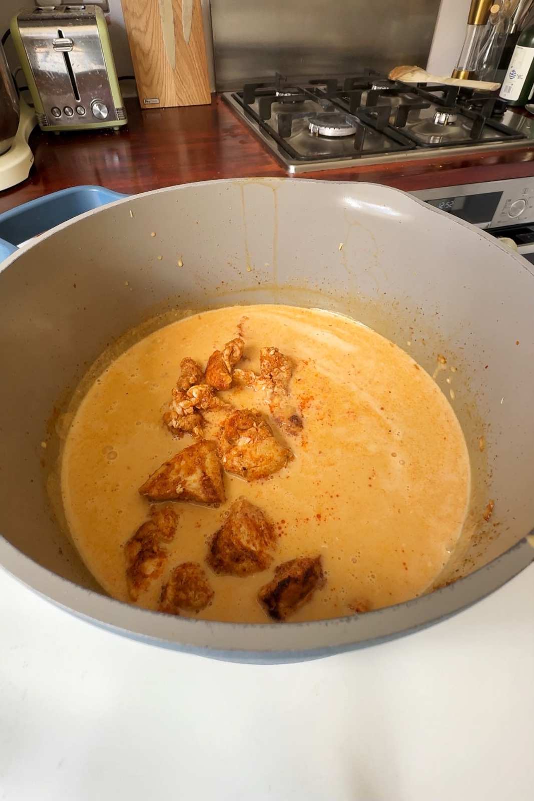 Cooking the chicken in the thai peanut coconut curry pot.