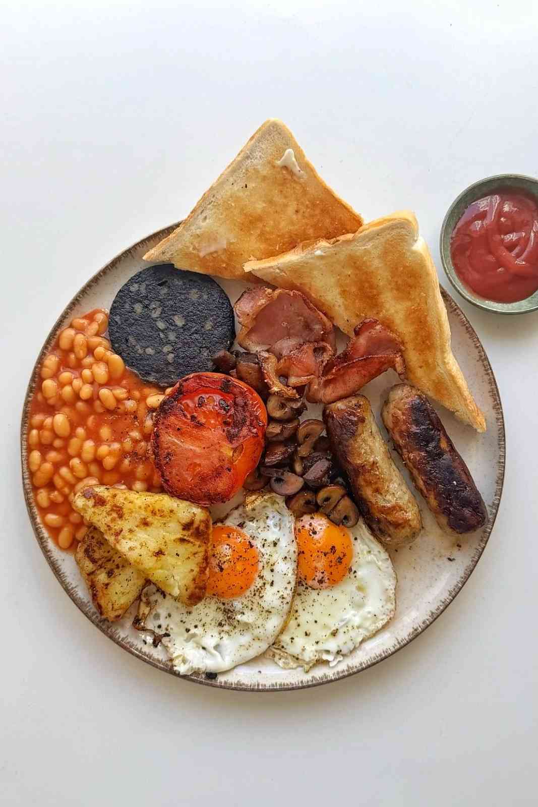 Full English breakfast on a white background.