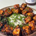 Black pepper tofu with rice in a bowl.