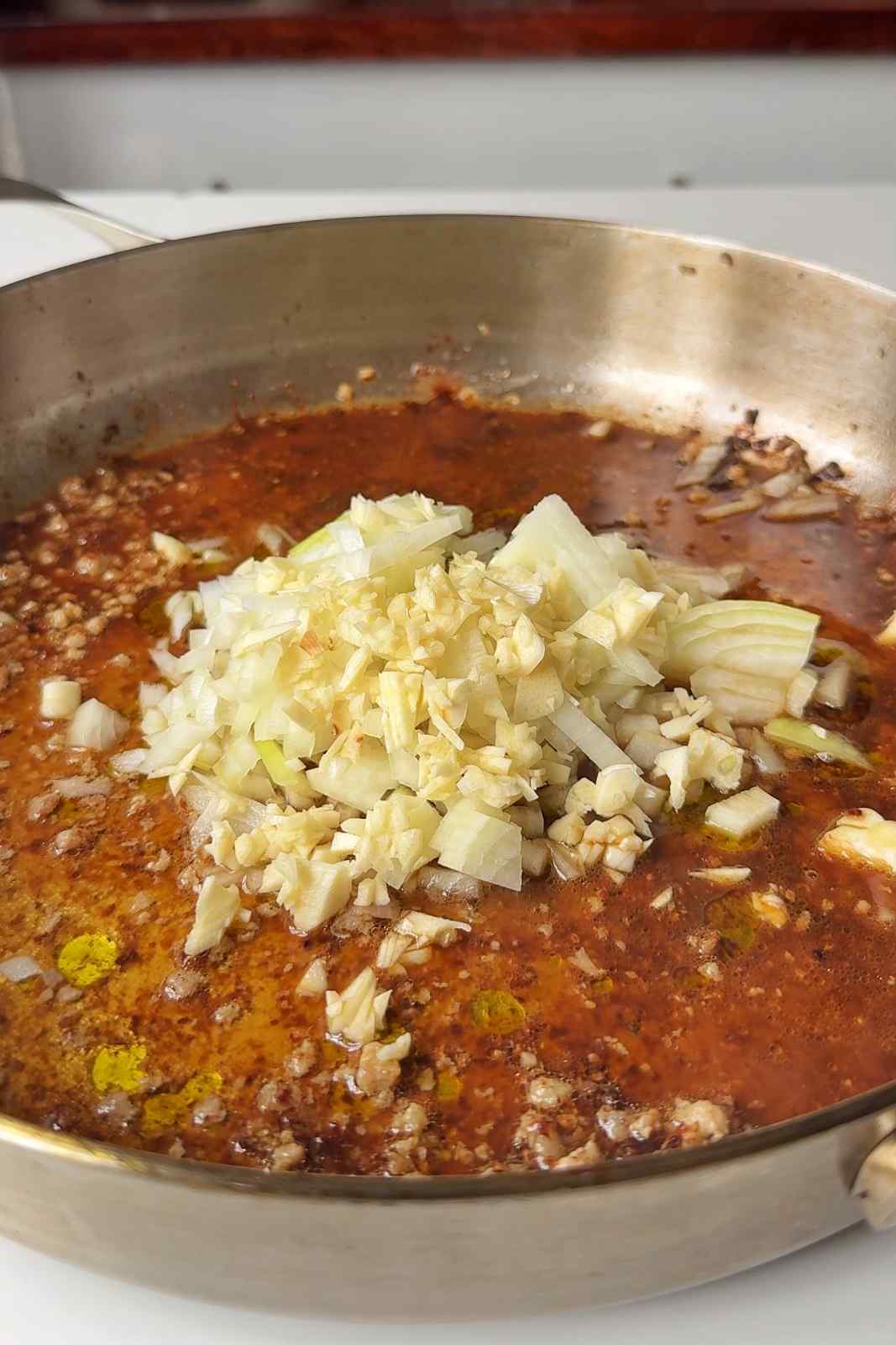 Frying garlic and onion in a pan.