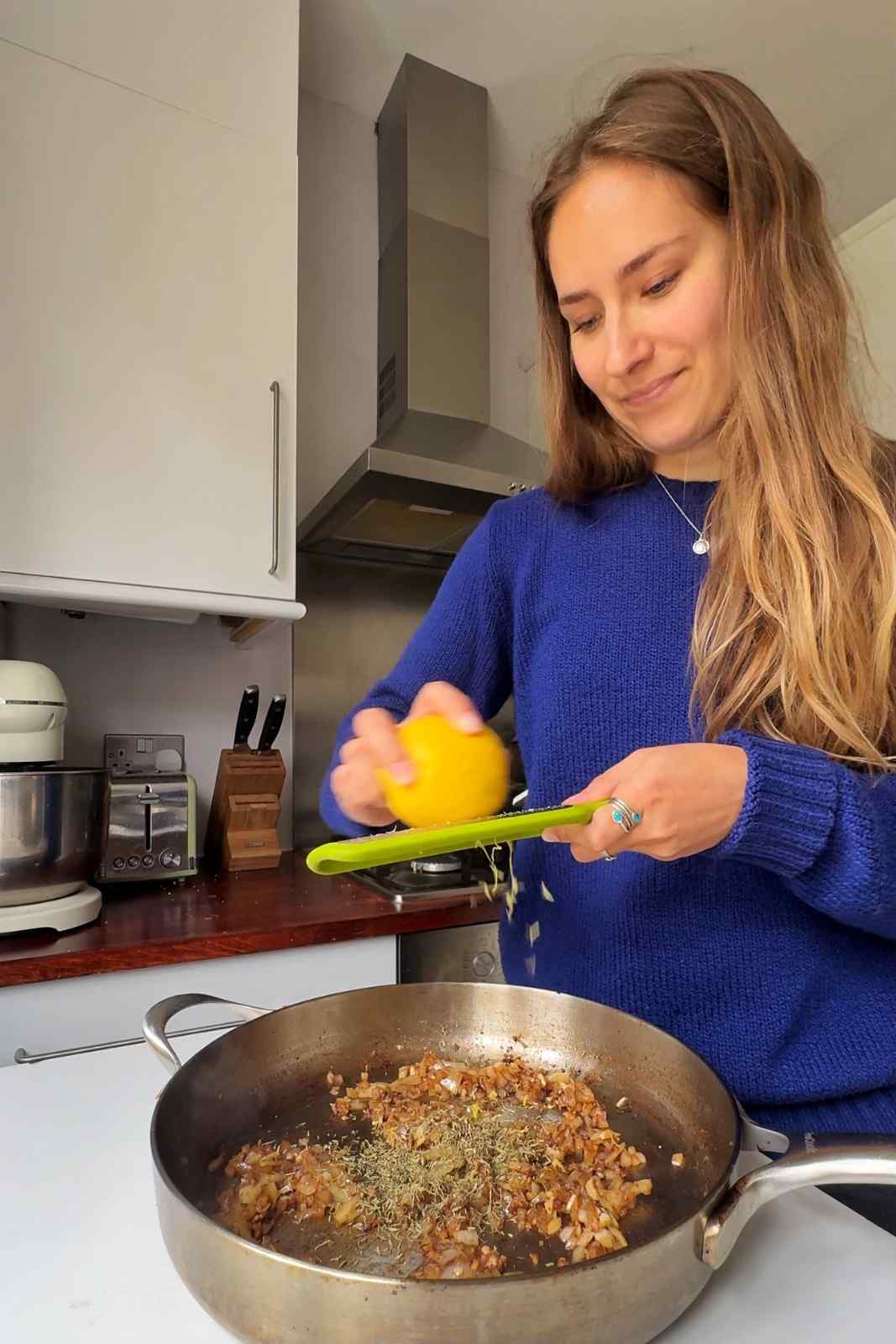 Zesting lemon into the pan by Emily Roz.