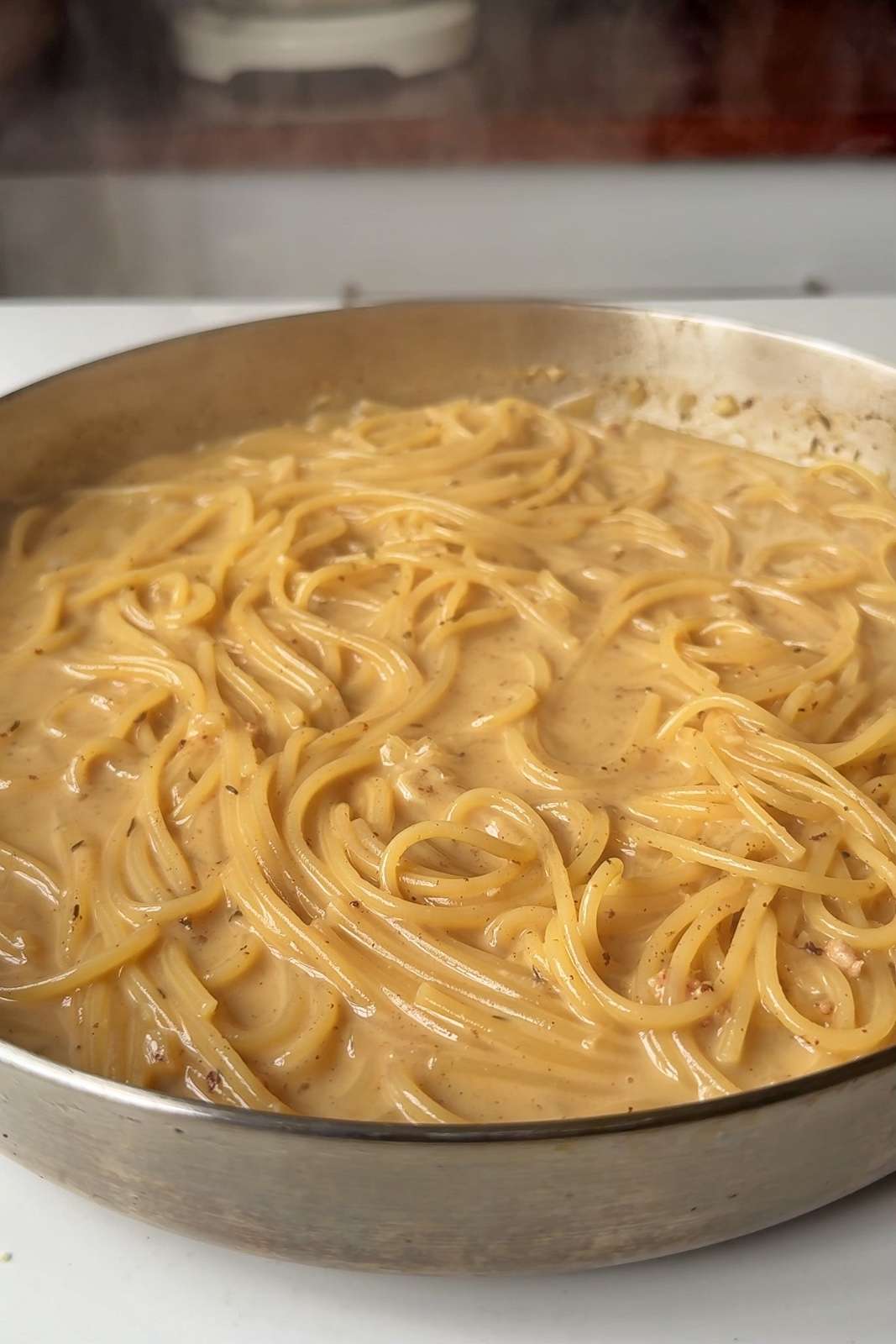 Spaghetti and sauce in a pan.
