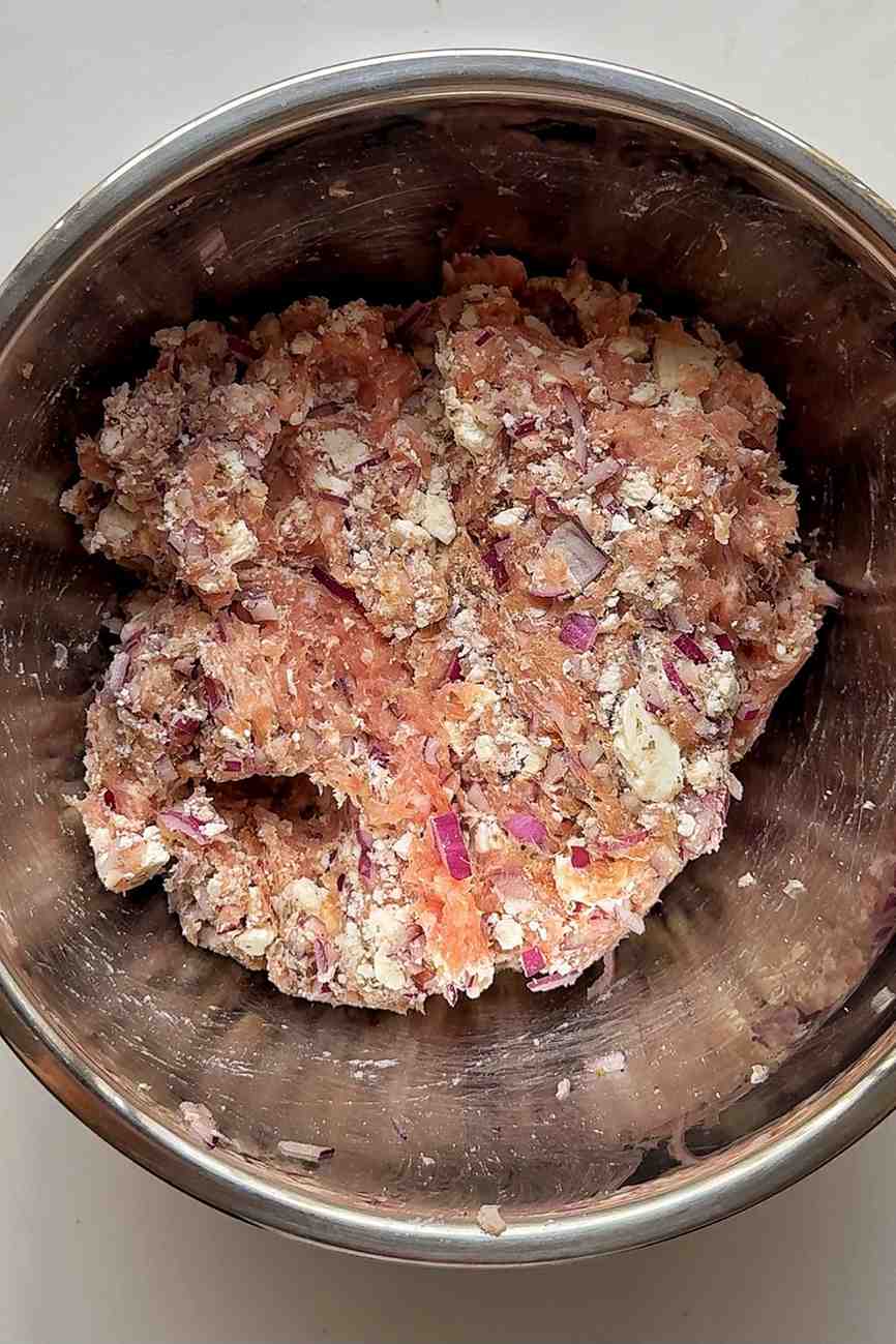 Ground chicken in a stainless steel bowl.