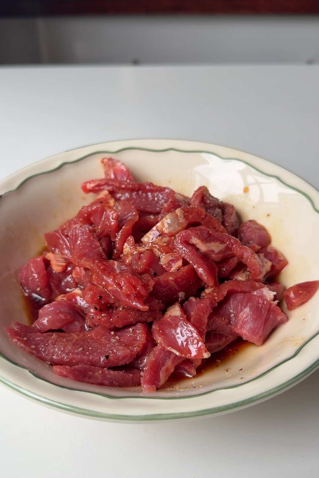 Marinating steak in soy sauce marinade.