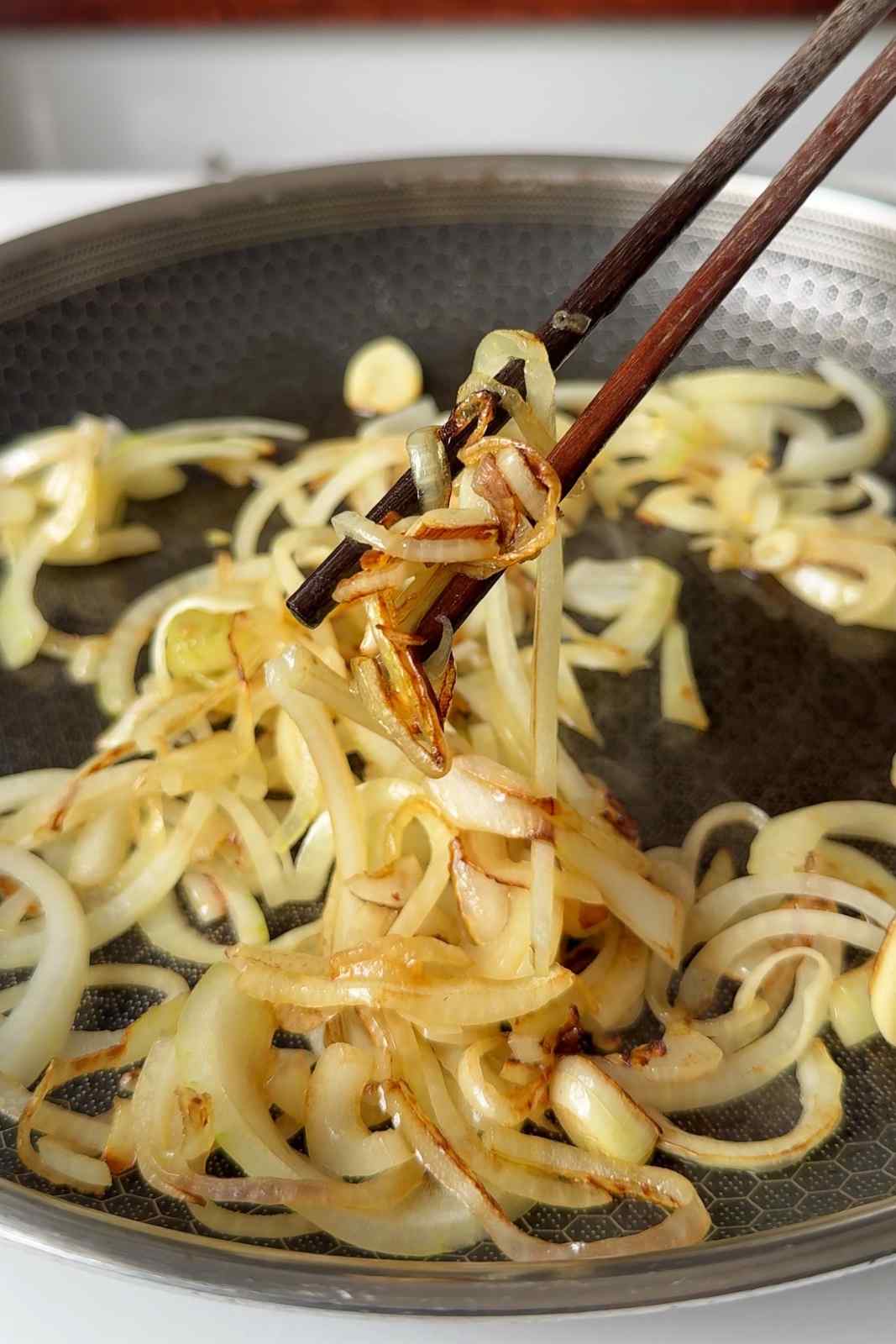 Frying onions and garlic until caramelised.