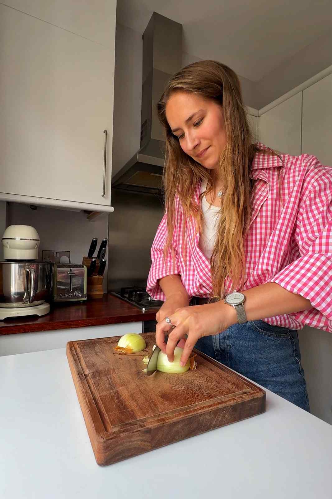 Slicing onions on a wooden chopping board.