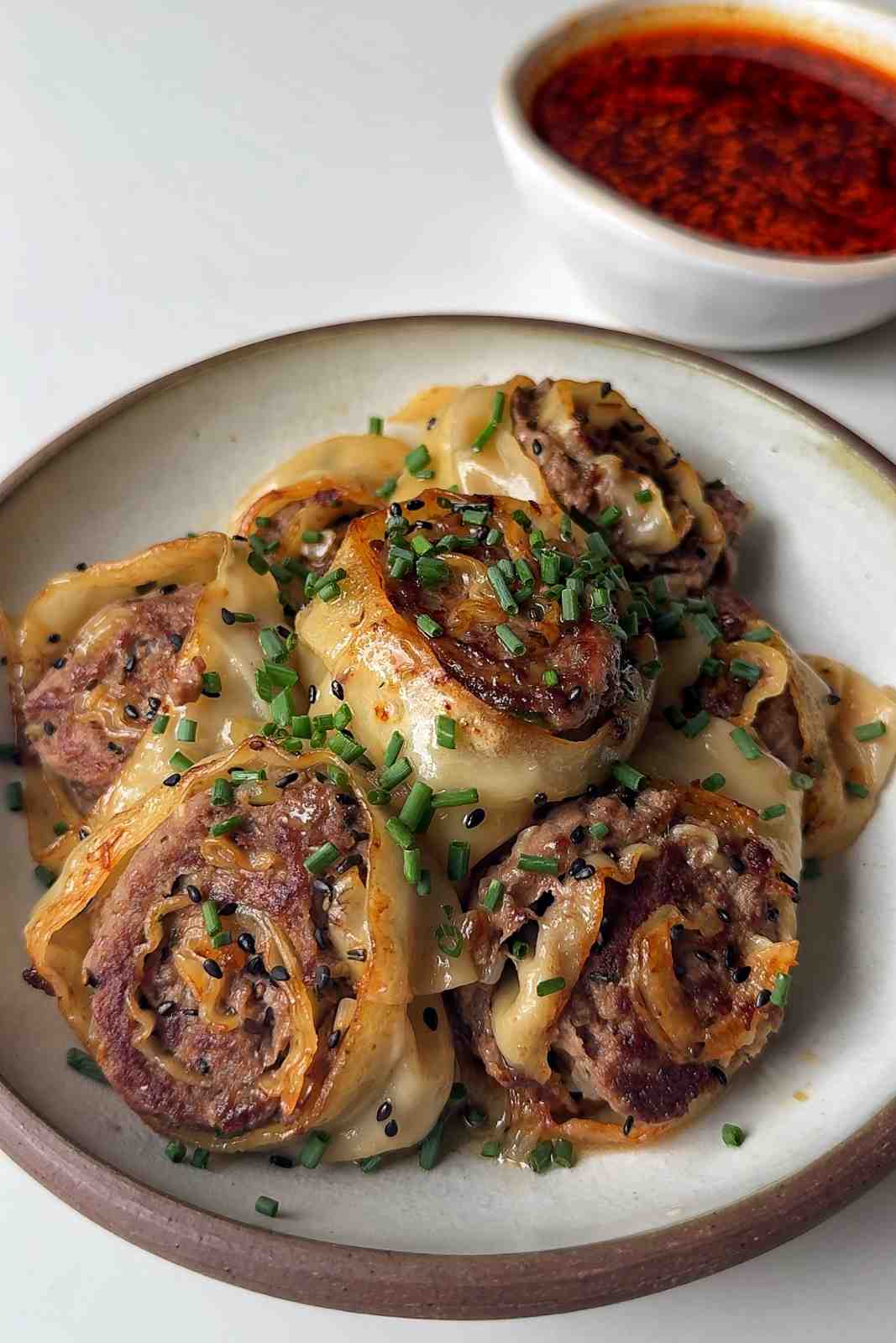 Dumpling hack dumpling wheels with chili oil broth dipping sauce.