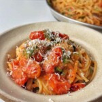 Roasted tomato pasta sauce in a bowl topped with parmesan.