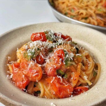 Roasted tomato pasta sauce in a bowl topped with parmesan.