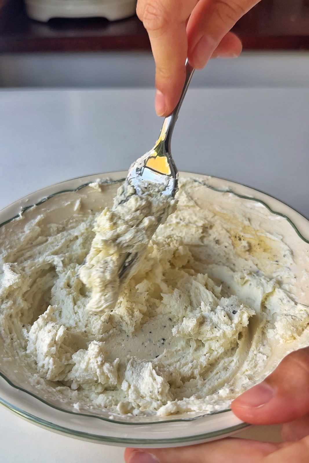 Making whipped honey goats cheese.