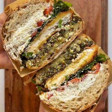 Cross section of a summer's day sandwich with goats cheese, pesto and fried chicken.