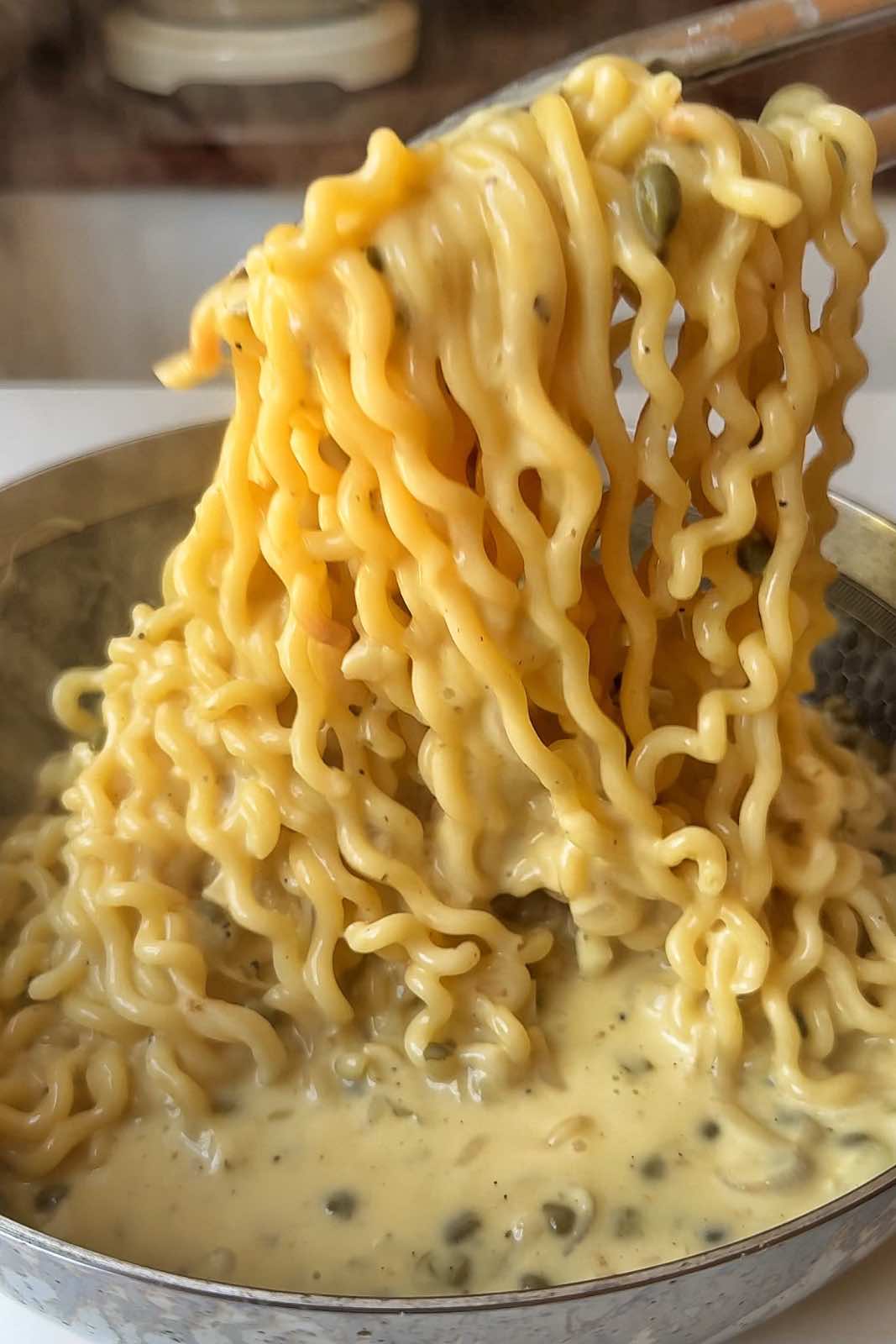 Cooking pasta in a creamy sauce.