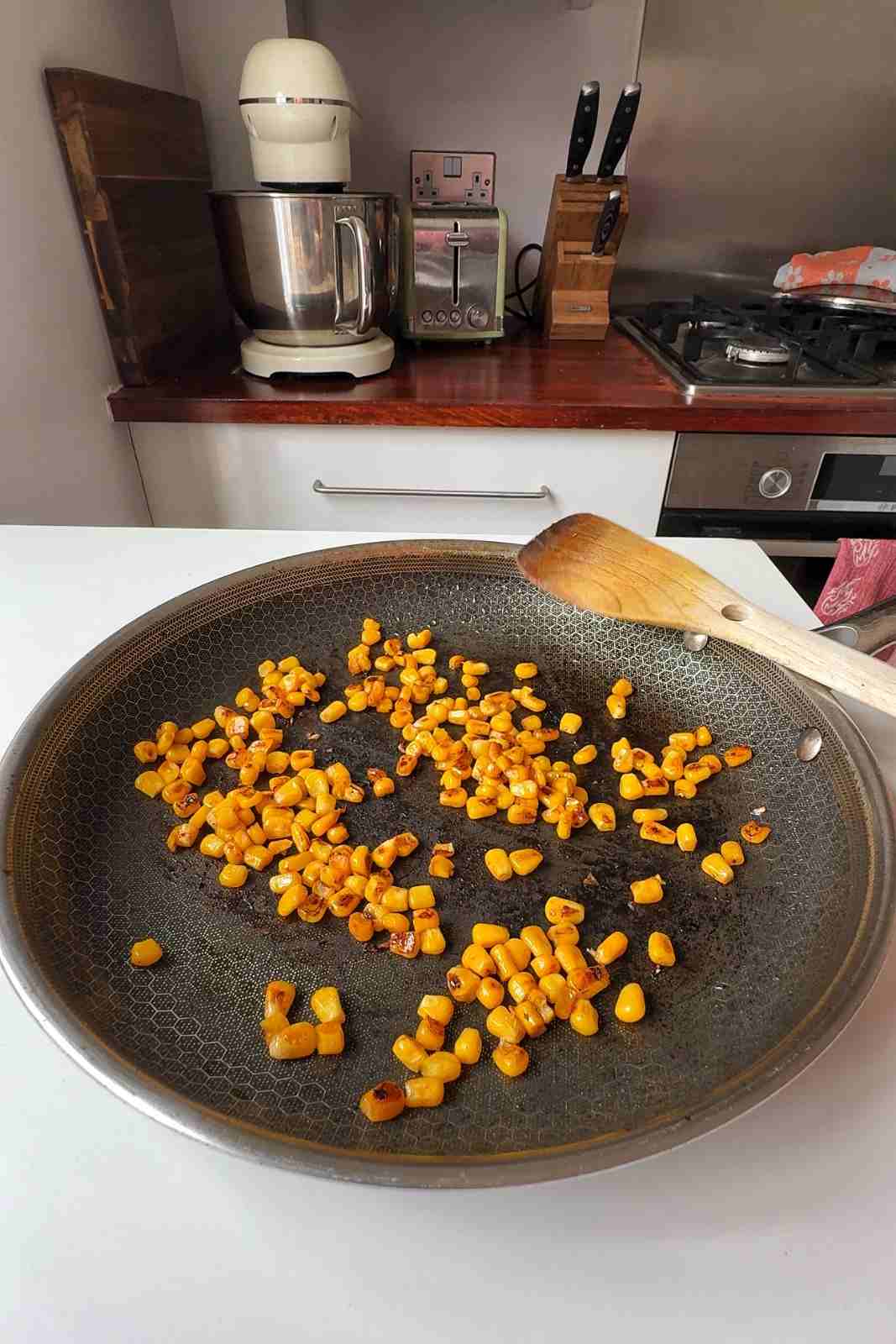 Canned corn charring in a hot skillet.