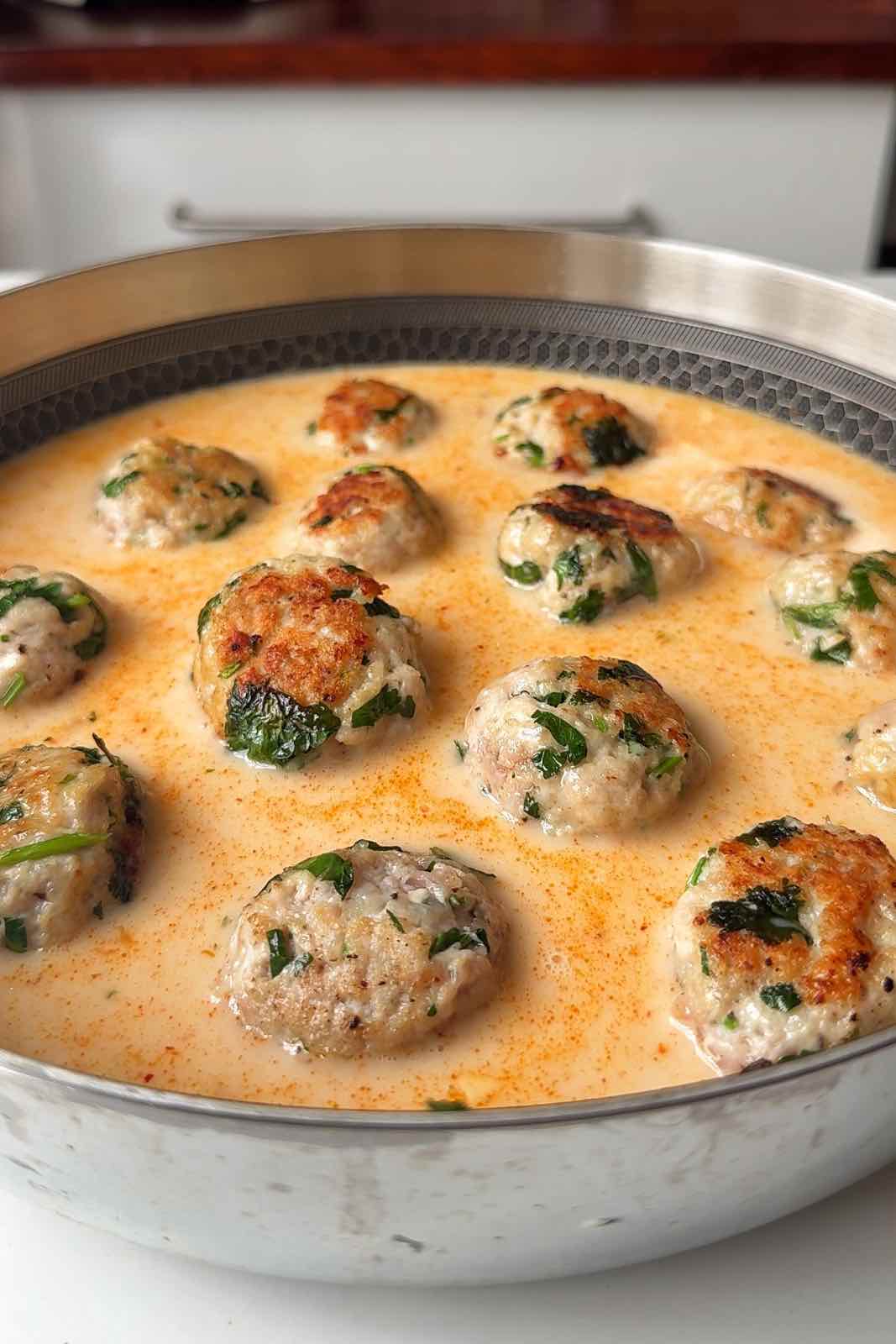 Pan filled with chicken Thai meatballs and Thai coconut broth.