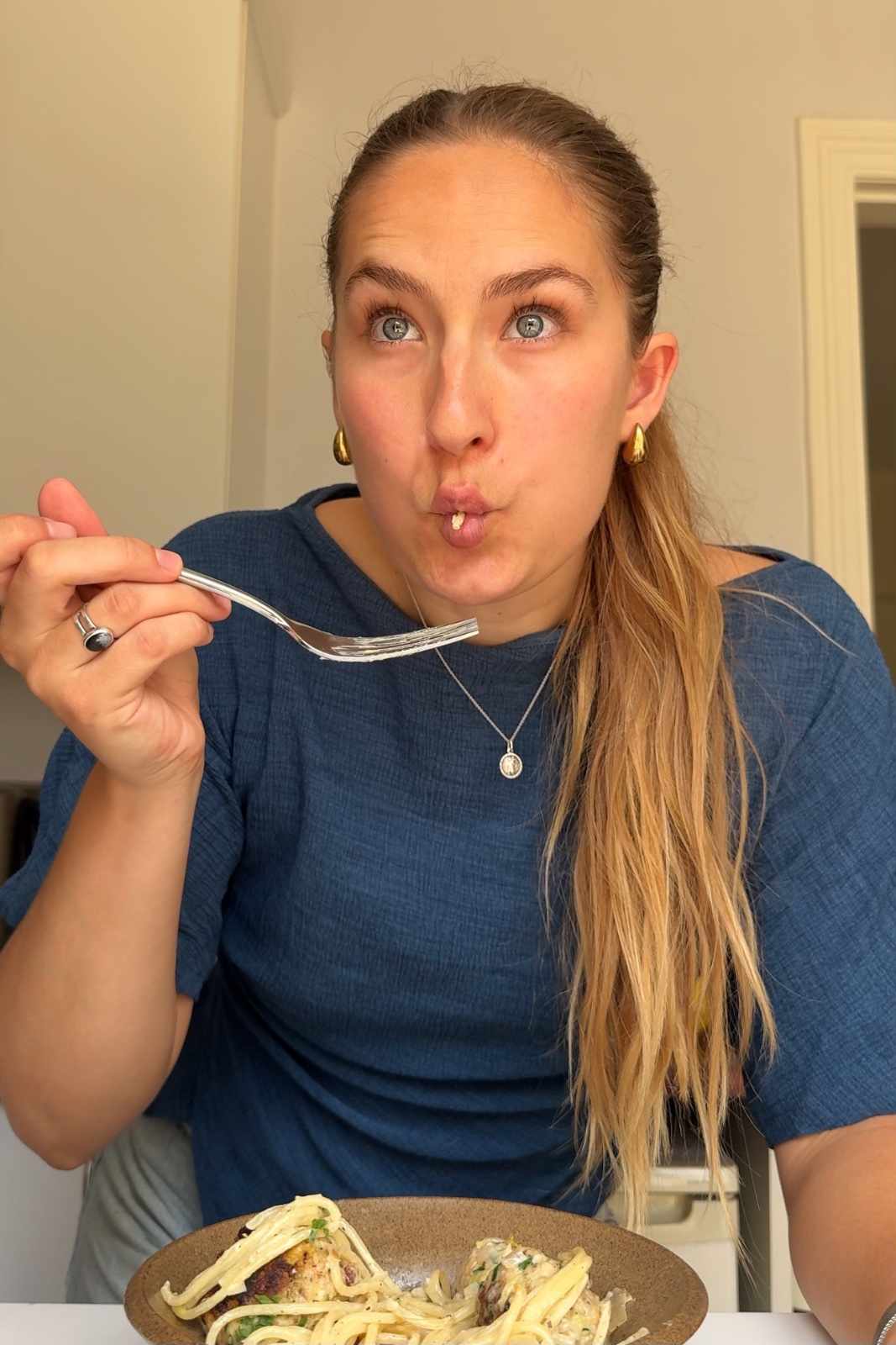 Emily Roz eating spaghetti zucchini meatballs.
