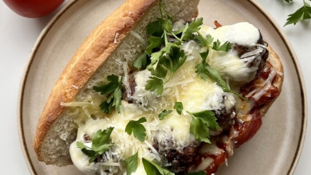 Homemade meatball sandwich with marinara sauce and melted cheese.