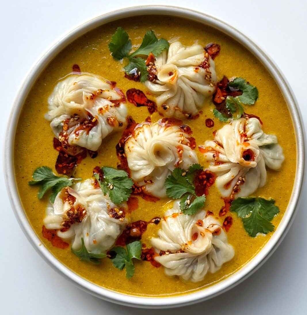 A plate of homemade jhol momo in sauce.