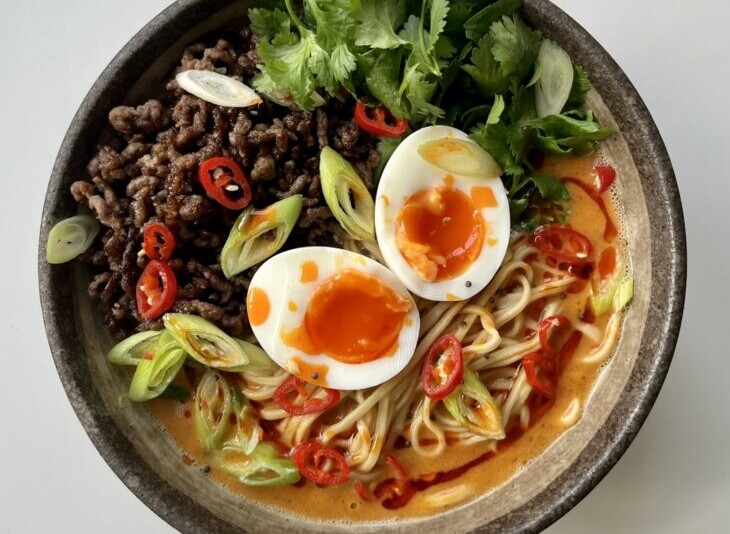 Chili oil drizzled on top of spicy beef noodle soup.