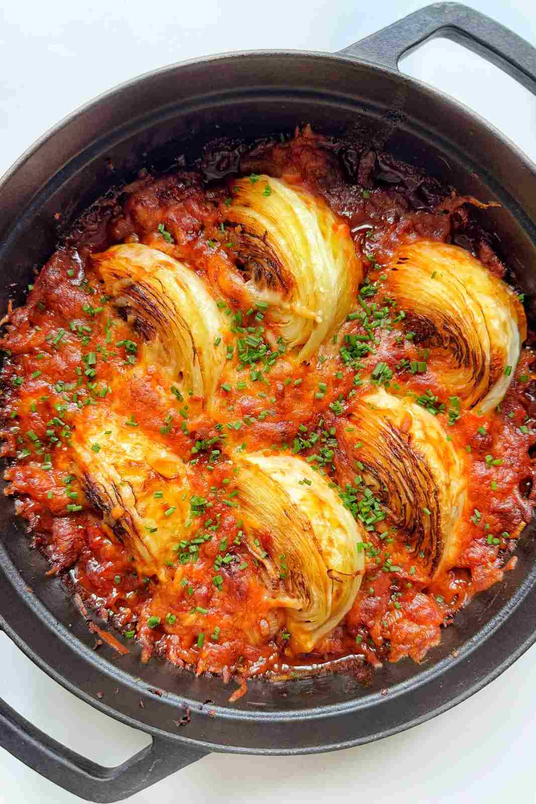 Roasted cabbage wedges in a spicy gochujang sauce with melted mozzarella and chives.