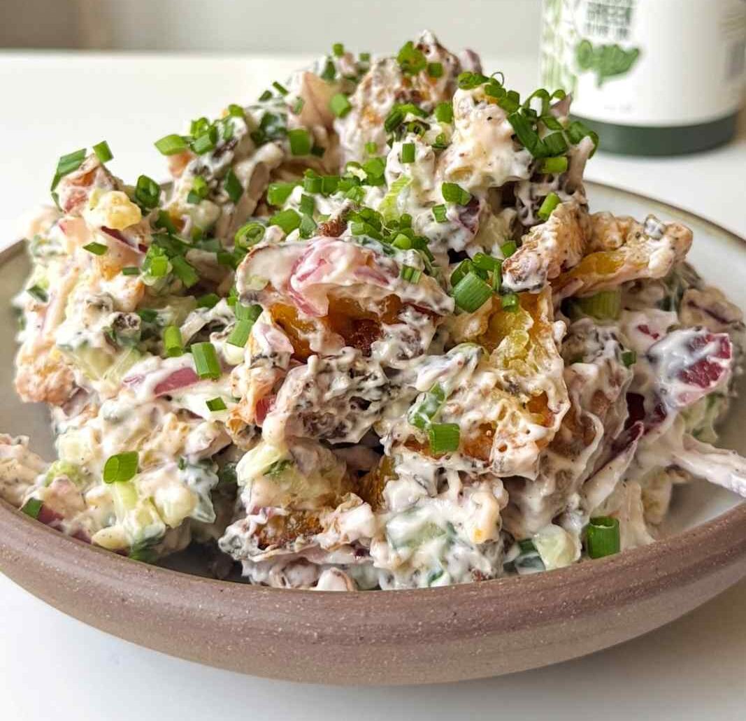 Crispy smashed potato salad with a creamy yogurt dressing, cucumber, red onion and chives.